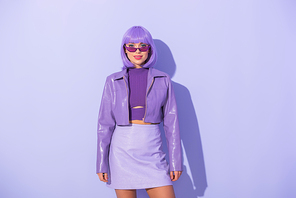 young woman dressed in doll style on violet colorful background
