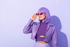 smiling young woman dressed in doll style on violet colorful background
