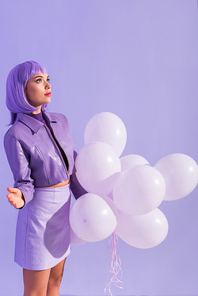 young woman dressed in doll style with balloons on violet colorful background