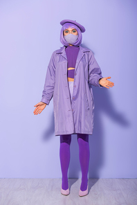 young woman dressed in doll style in medical mask and beret on violet colorful background