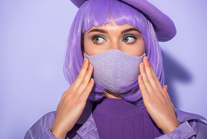 young woman dressed in doll style in medical mask and beret on violet colorful background