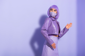 young woman dressed in doll style in medical mask on violet colorful background