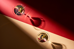 Top view of two cocktails on red and beige background