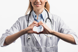 cropped view of happy nurse in white coat showing hears sign with hands isolated on white