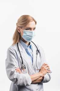nurse in medical mask standing with crossed arms isolated on white
