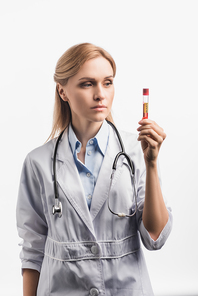 nurse in white coat looking at test tube with covid lettering isolated on white