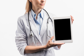 cropped view of nurse in white coat holding tablet with blank screen isolated on white