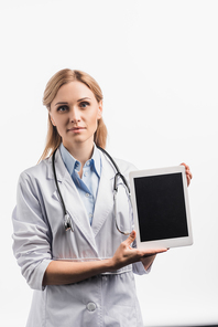 nurse in white coat holding digital tablet with blank screen isolated on white