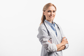 joyful nurse in white coat standing with crossed arms isolated on white
