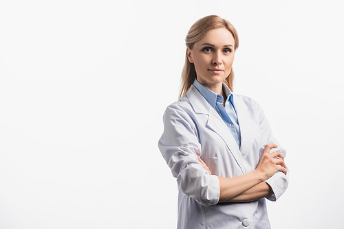 confident nurse in white coat standing with crossed arms isolated on white