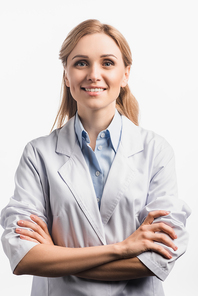 positive nurse in white coat standing with crossed arms isolated on white