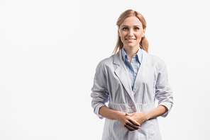 happy nurse in white coat standing with clenched hands isolated on white