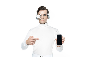 Cyborg in eye lens and headphones pointing with finger at smartphone with blank screen isolated on white