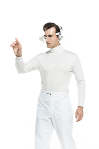 Brunette cyborg in white clothes and headphones touching something isolated on white