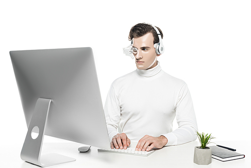 Cyborg in eye lens and headphones using computer near plant and notebook isolated on white