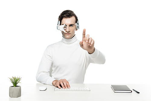 Cyborg in headphones and eye lens touching something and using computer keyboard near notebook and plant isolated on white