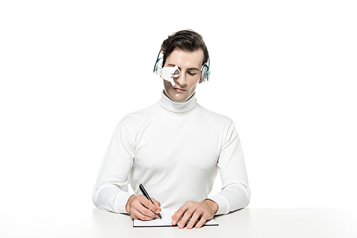 Cyborg in headphones and eye lens writing on notebook isolated on white