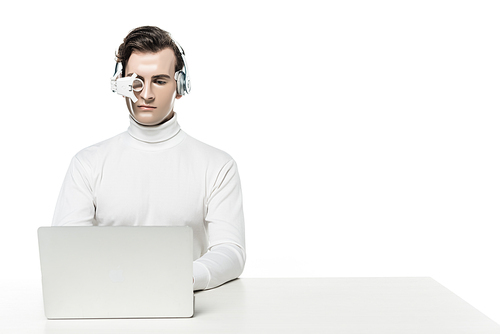 Cyborg in headphones and digital eye lens using laptop isolated on white