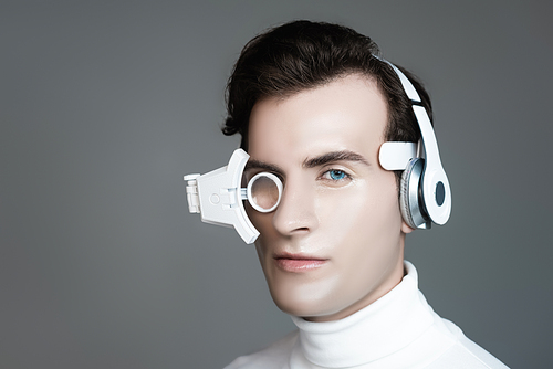 Cyborg in headphones and eye lens  isolated on grey