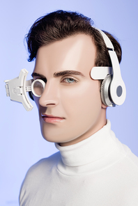 Brunette cyborg man in headphones and eye lens  isolated on blue