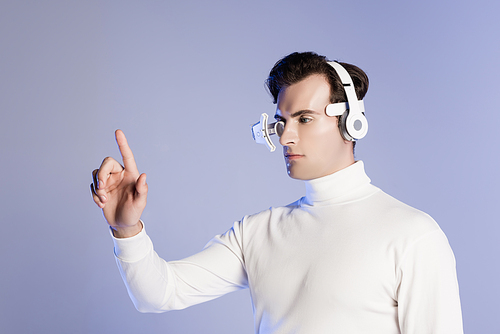 Cyborg in eye lens and headphones touching something isolated on purple