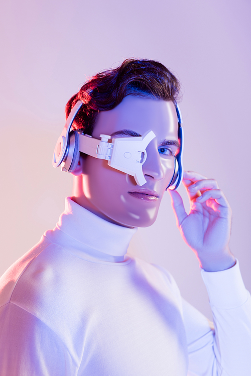 Cyborg in headphones and eye lens  on purple background