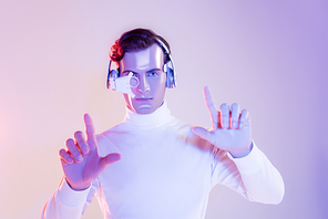 Cyborg in eye lens and headphones using something on purple background