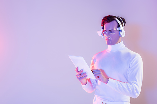 Cyborg in headphones and eye lens using digital tablet on purple background