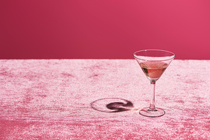rose wine in glass on velour pink cloth isolated on pink, girlish concept