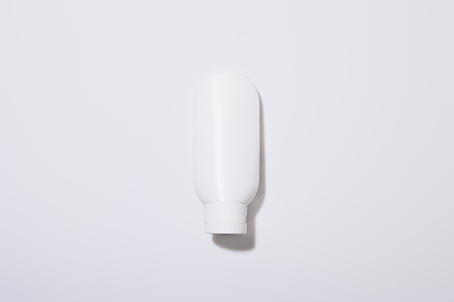 Top view of cosmetic tube on grey background