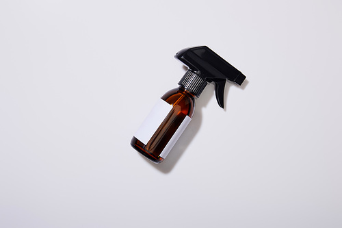 Top view of dispenser cosmetic bottle of oil on grey background