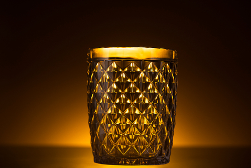 faceted glass in dark with warm back light