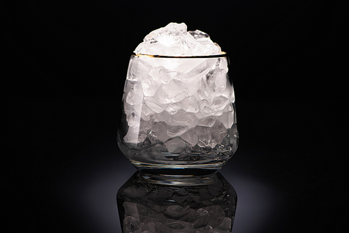 transparent glass with ice on black background