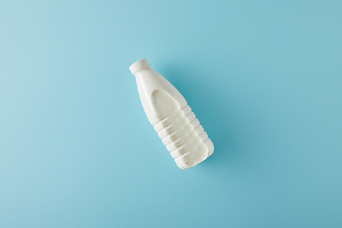 Top view of bottle of milk on blue background