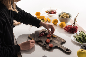 cropped view of commercial female photographer making food composition for photo shoot