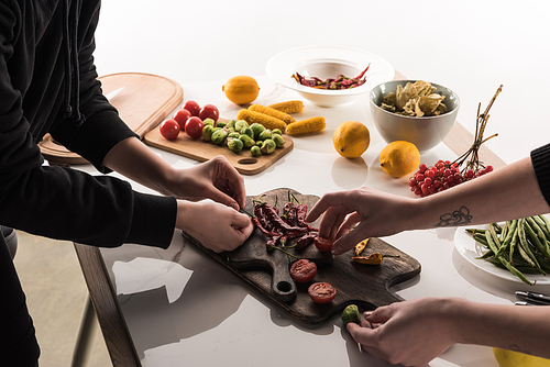 cropped view of commercial photographers making food composition for photo shoot