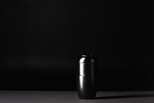 urn with ashes on black background, funeral concept