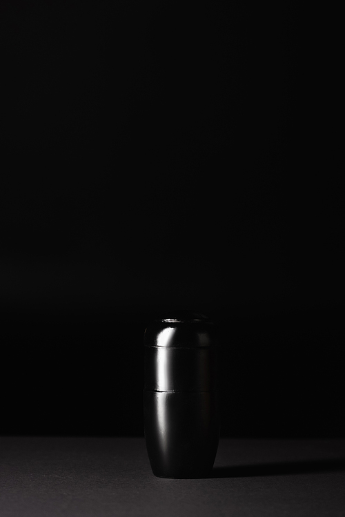 urn with ashes on black background, funeral concept