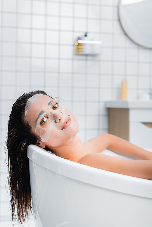 young woman in face mask  while taking bath