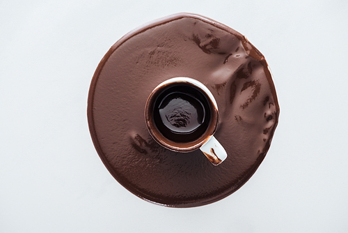 Top view of dirty cup with circle of dark chocolate on white background