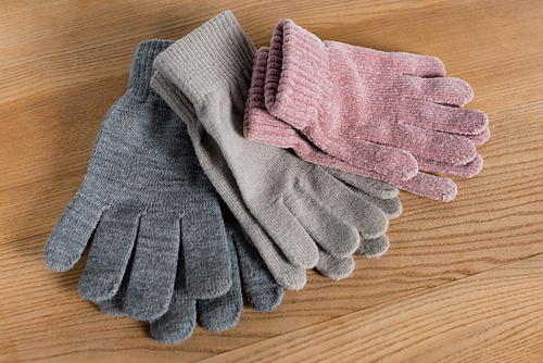 Top view of cozy gloves on wooden surface