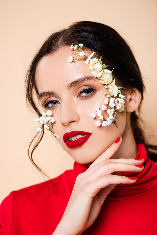 young woman with red lips and flowers on face  isolated on pink
