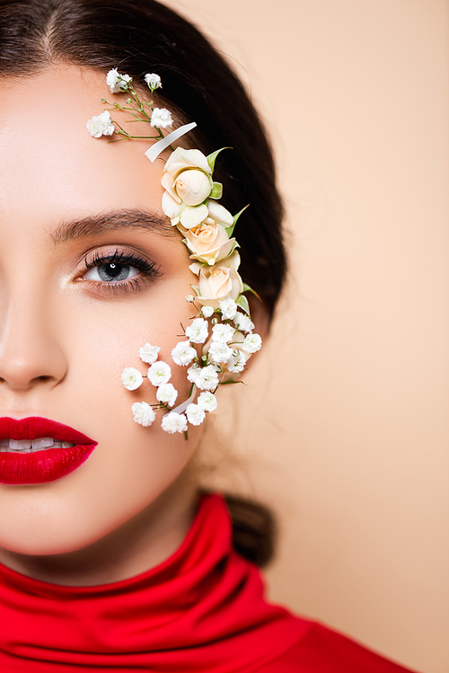 cropped view of young woman with red lips and flowers on face  isolated on pink