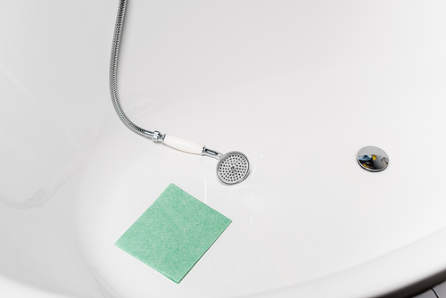 High angle view of rag near shower in white bathtub