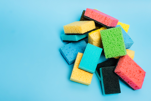 Top view of colorful sponges on blue background
