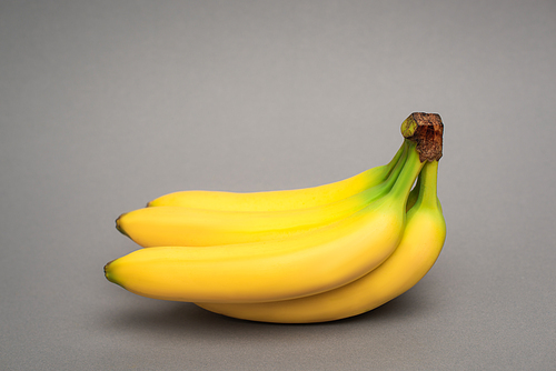 yellow ripe bananas on grey background