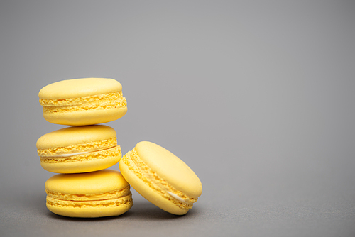 delicious yellow macarons on grey background