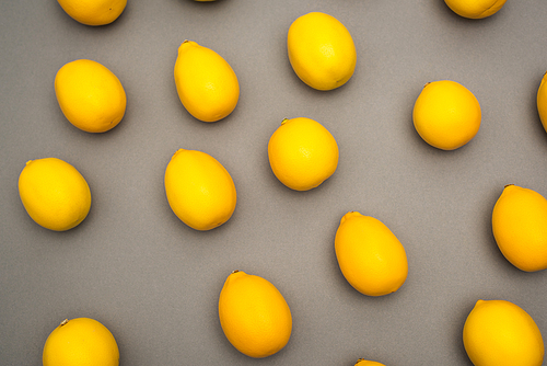 high angle view of fresh and yellow lemons on grey background
