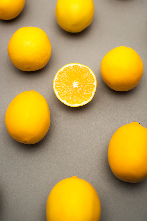 high angle view of juicy and yellow lemons on grey background