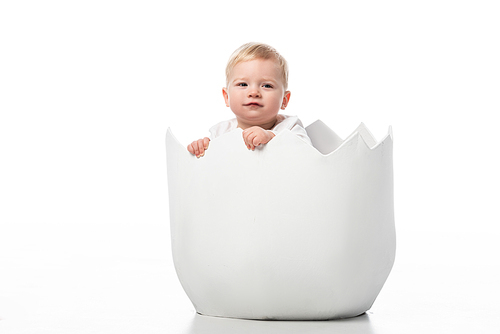 Cute child inside eggshell on white background